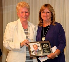 Ann King presents the ECADSIDA Nevins Award to Carole Grills.
